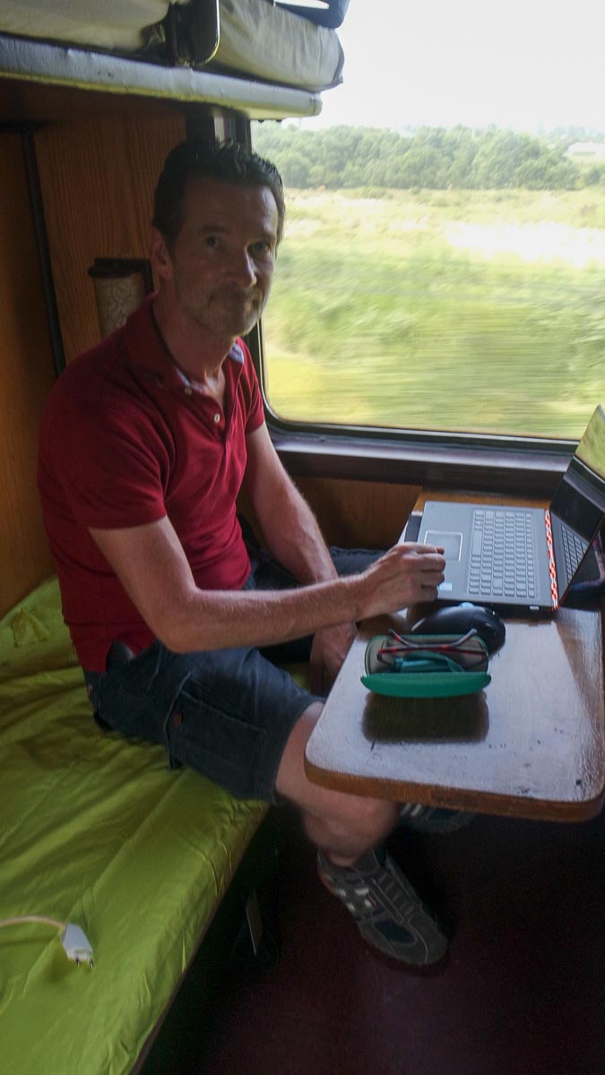 Working on the train while seated on our lime green camping sheet
